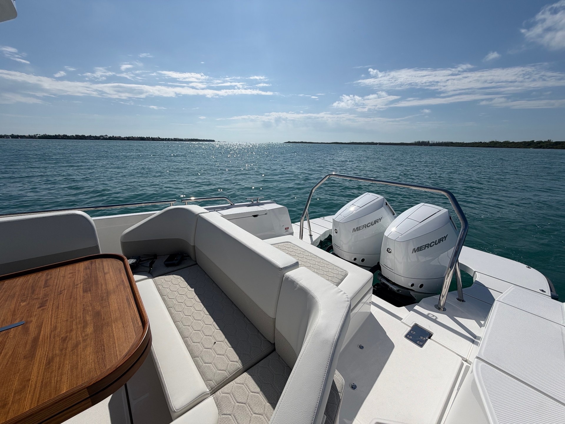 Aft cockpit and starboard dinette of the new Nimbus T12 — note the redesigned seating, teak table, and twin Mercury V10 Verados.